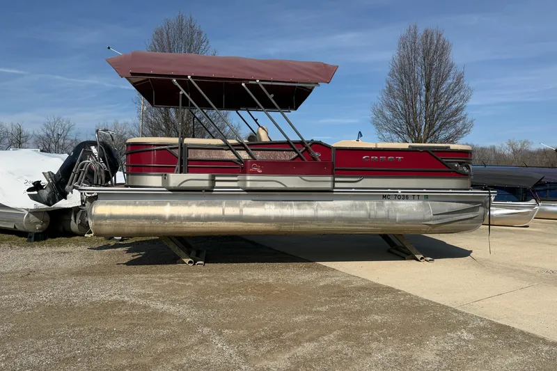 Slide: The Image of 2015 Crest Classic 230 SLC pontoon boat with canopy, parked on a trailer. - 15
