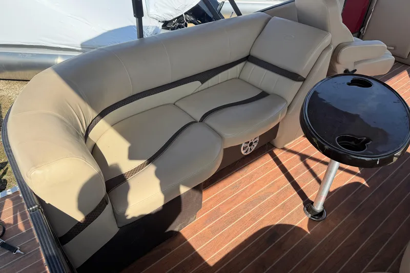 Slide: The Image of Luxurious seating on 2015 Crest Classic 230 SLC boat with wooden deck and table. - 6
