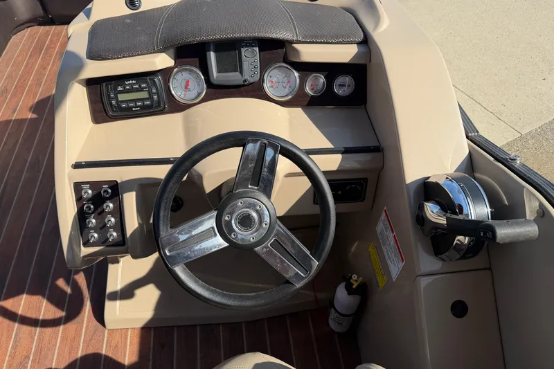 Slide: The Image of Steering console of 2015 Crest Classic 230 SLC boat with gauges and controls. - 7