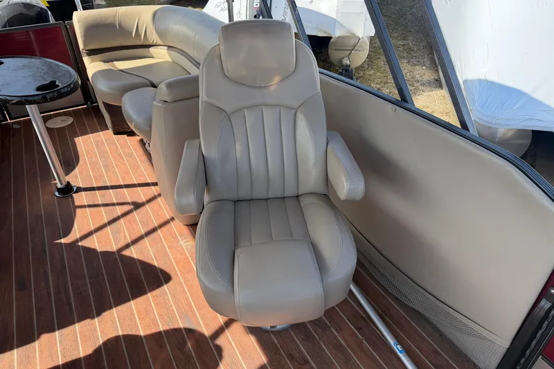 Slide: The Image of Interior of 2015 Crest Classic 230 SLC boat with beige seating and wood flooring. - 9