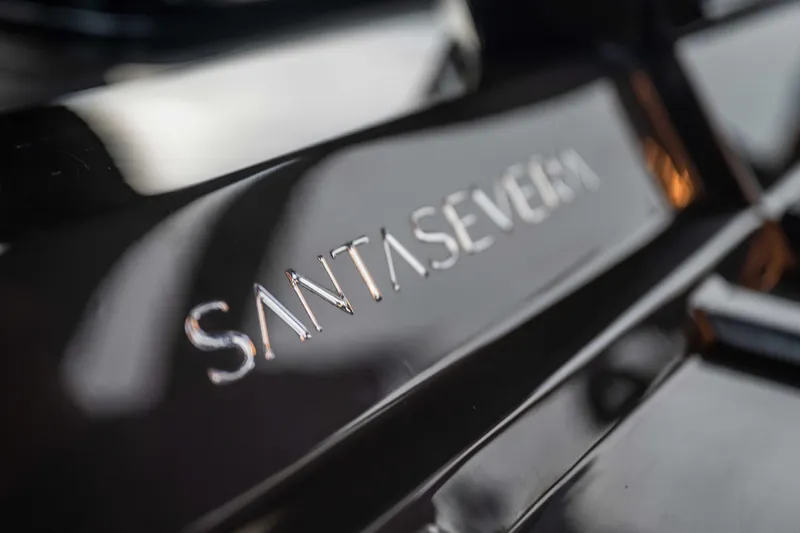 Slide: The Image of Close-up of Santasevera52 logo on a sleek black surface, 2026 model. - 11