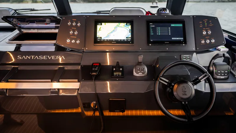 Slide: The Image of Control panel of 2026 Santasevera52 yacht with navigation screens and steering wheel. - 13