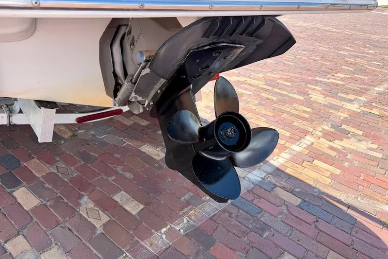 Slide: The Image of Close-up of a 2005 Crownline 216 LS boat propeller on a brick surface. - 10