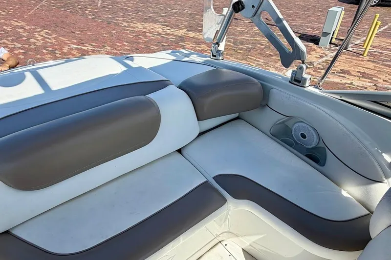 Slide: The Image of Interior seating of a 2005 Crownline 216 LS boat, featuring cushioned seats and cup holders. - 14