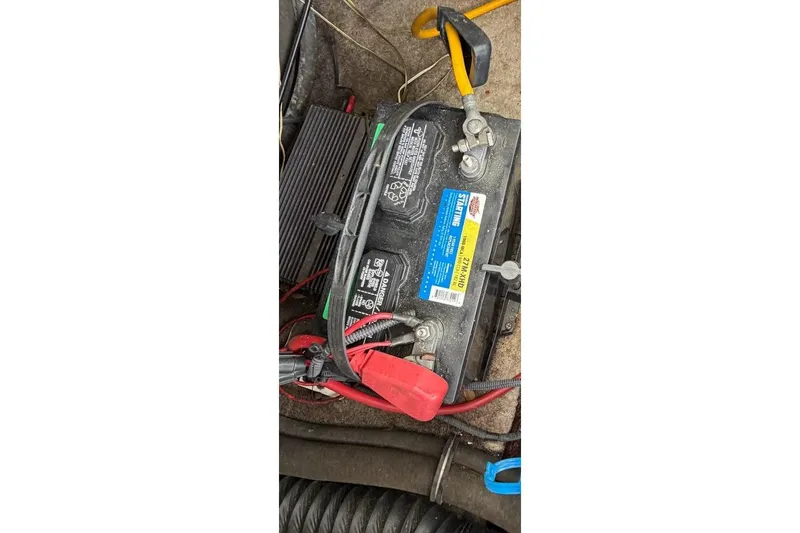 Slide: The Image of Battery compartment of a 2005 Crownline 216 LS boat with visible wiring. - 17