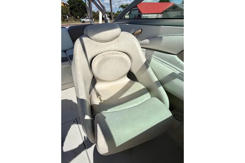 Slide: The Image of 2005 Crownline 216 LS boat seat, white upholstery, outdoor setting. - 18
