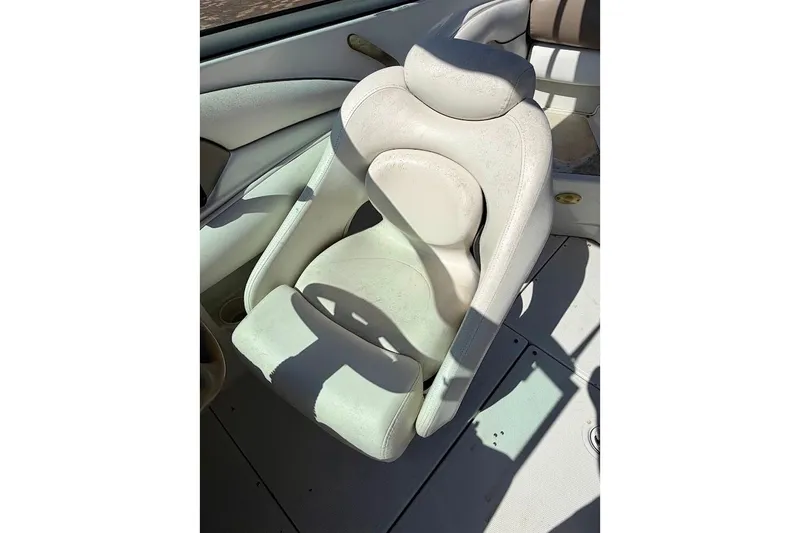 Slide: The Image of 2005 Crownline 216 LS boat seat, white upholstery, sunlight casting shadows. - 19