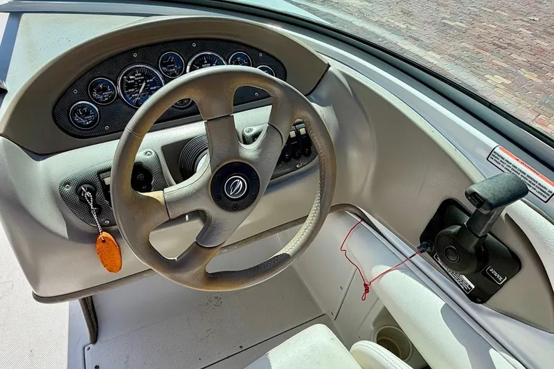 Slide: The Image of Steering wheel and dashboard of a 2005 Crownline 216 LS boat. - 20