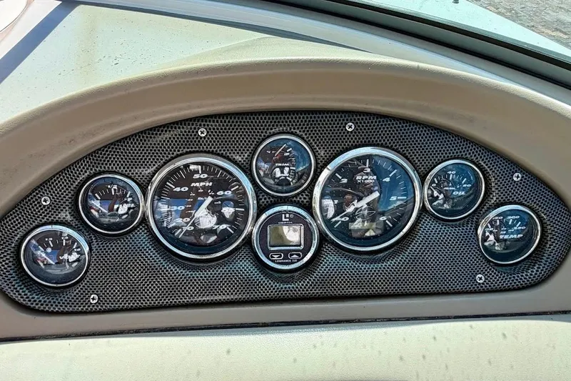 Slide: The Image of Dashboard of a 2005 Crownline 216 LS boat with various gauges and controls. - 23