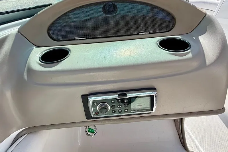 Slide: The Image of Dashboard of a 2005 Crownline 216 LS boat with stereo system and cup holders. - 24