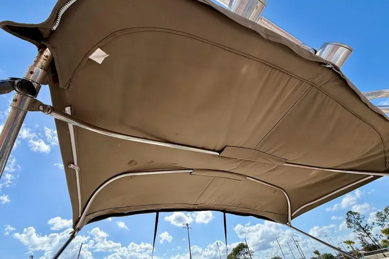 Slide: The Image of Bimini top of a 2005 Crownline 216 LS boat against a clear blue sky. - 29