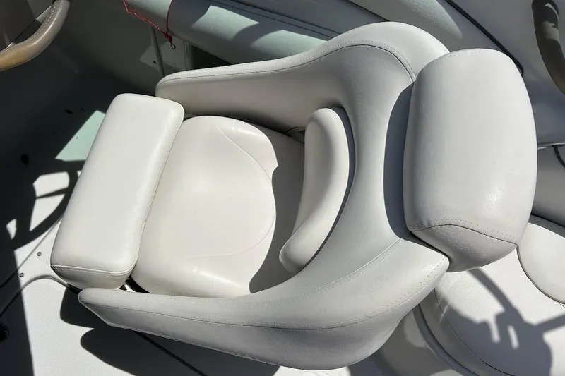 Slide: The Image of White leather seat in a 2005 Crownline 216 LS boat, showcasing ergonomic design. - 30