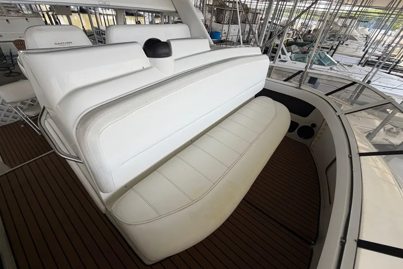 Slide: The Image of 1998 Carver 355 Aft Cabin Motor Yacht interior with white seating and wooden flooring. - 12