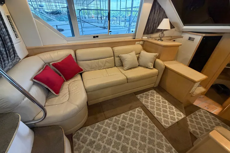 Slide: The Image of Luxurious interior of 1998 Carver 355 Aft Cabin Motor Yacht with beige seating and red pillows. - 16