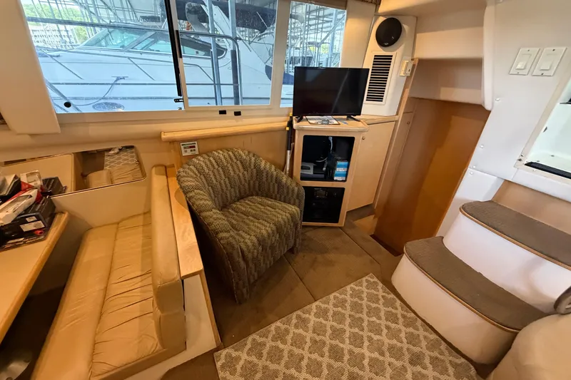 Slide: The Image of Interior of 1998 Carver 355 Aft Cabin Motor Yacht with seating, TV, and stairs. - 17