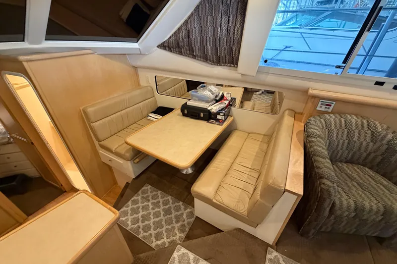 Slide: The Image of Interior of 1998 Carver 355 Aft Cabin Motor Yacht with dining area and seating. - 18