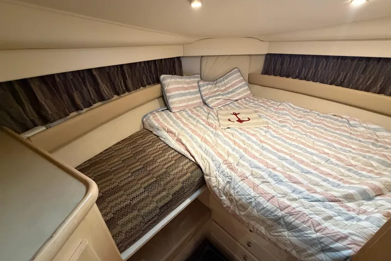 Slide: The Image of Cozy bedroom in 1998 Carver 355 Aft Cabin Motor Yacht with striped bedding. - 21