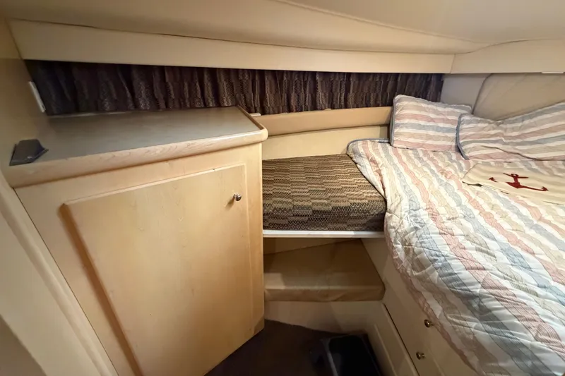 Slide: The Image of Cozy cabin interior of 1998 Carver 355 Aft Cabin Motor Yacht with bed and storage. - 22