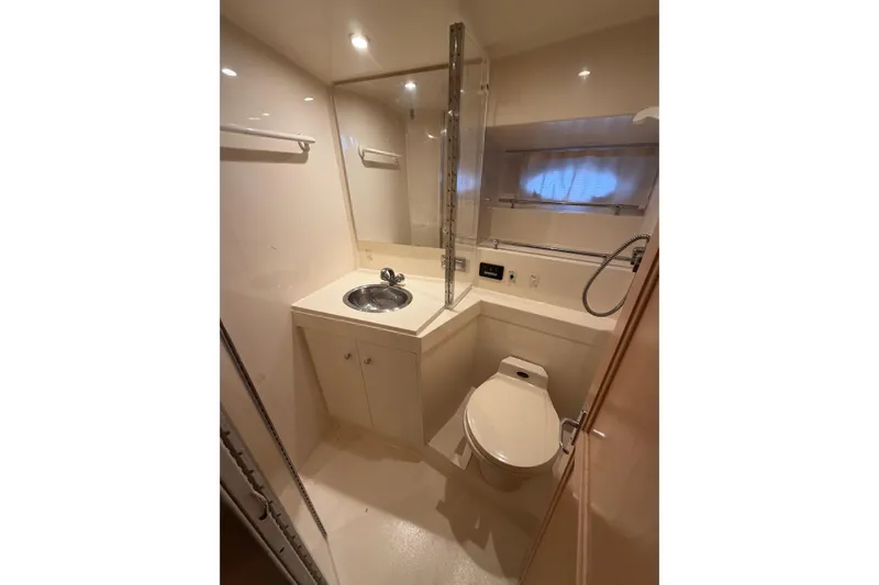 Slide: The Image of Bathroom interior of 1998 Carver 355 Aft Cabin Motor Yacht, featuring sink and toilet. - 23