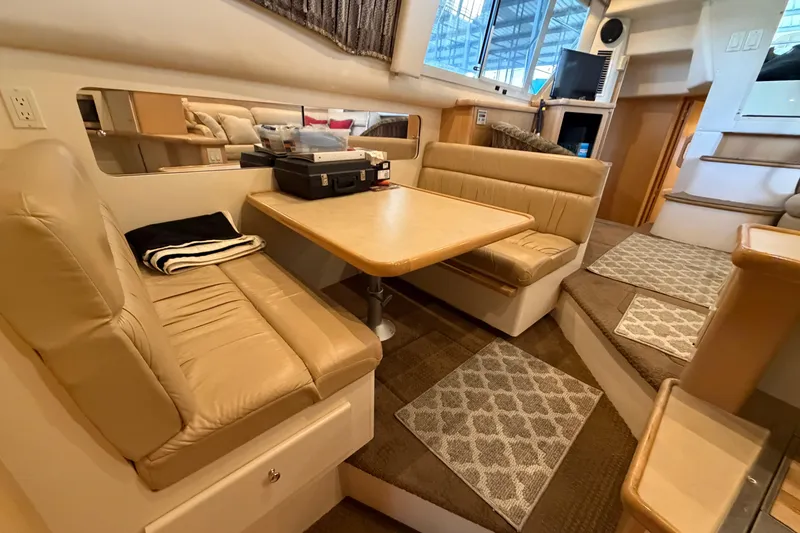 Slide: The Image of Interior of 1998 Carver 355 Aft Cabin Motor Yacht with beige seating and dining area. - 24