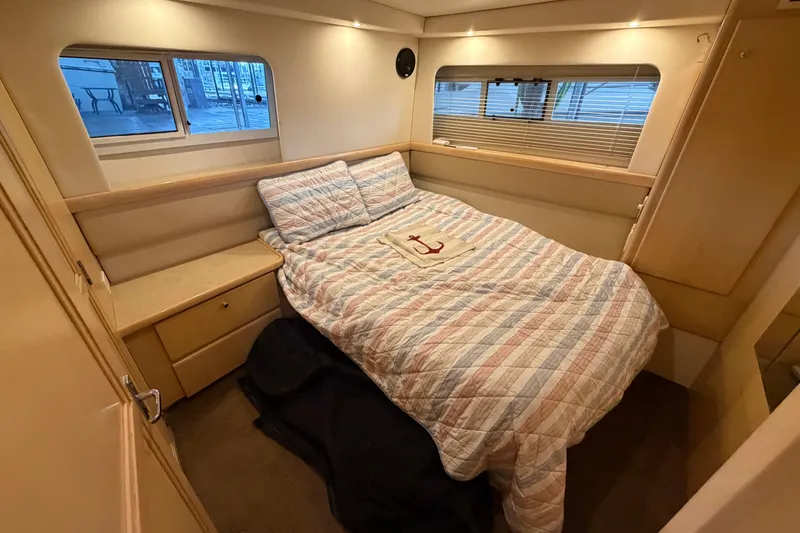 Slide: The Image of Cozy bedroom in 1998 Carver 355 Aft Cabin Motor Yacht with striped bedding. - 25