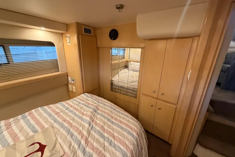 Slide: The Image of Interior of 1998 Carver 355 Aft Cabin Motor Yacht with cozy bedroom and wooden cabinetry. - 26