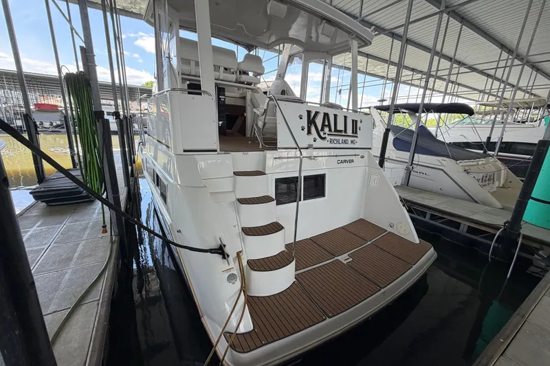 Slide: The Image of 1998 Carver 355 Aft Cabin Motor Yacht docked in marina, rear view. - 3