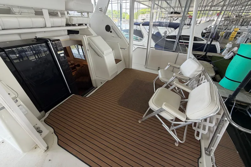 Slide: The Image of 1998 Carver 355 Aft Cabin Motor Yacht deck with seating and interior view. - 4