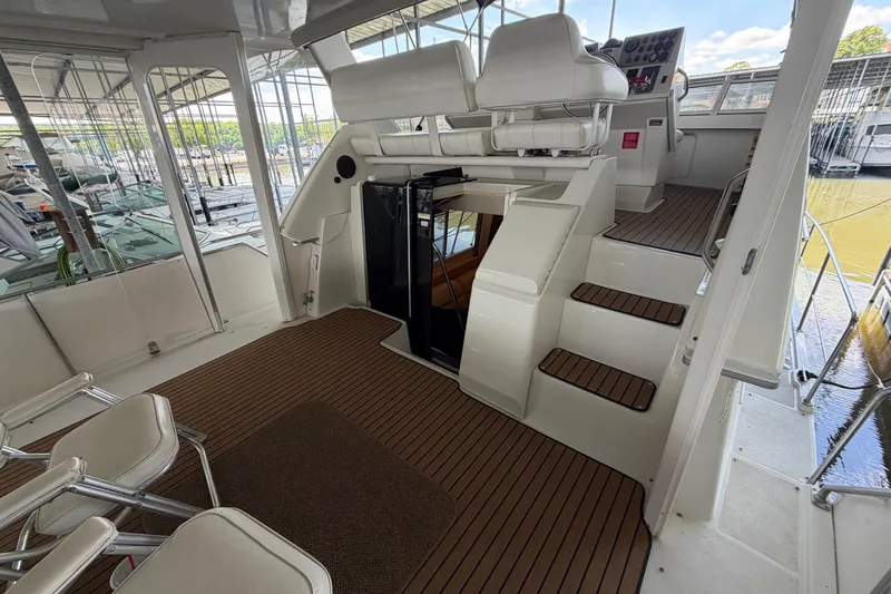 Slide: The Image of 1998 Carver 355 Aft Cabin Motor Yacht interior with helm and seating area. - 5