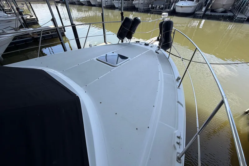 Slide: The Image of 1998 Carver 355 Aft Cabin Motor Yacht docked, showcasing bow and deck details. - 6