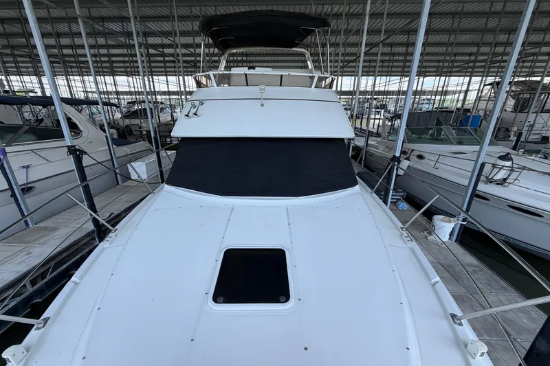Slide: The Image of 1998 Carver 355 Aft Cabin Motor Yacht docked in a covered marina. - 8