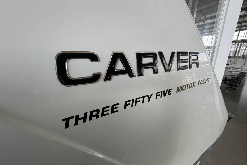 Slide: The Image of 1998 Carver 355 Aft Cabin Motor Yacht logo in a marina setting. - 9