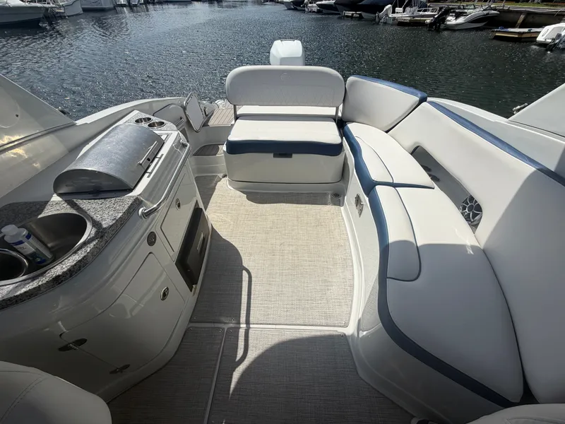 Slide: The Image of Interior of 2023 Crownline Eclipse E285 XS with seating and kitchenette. - 10