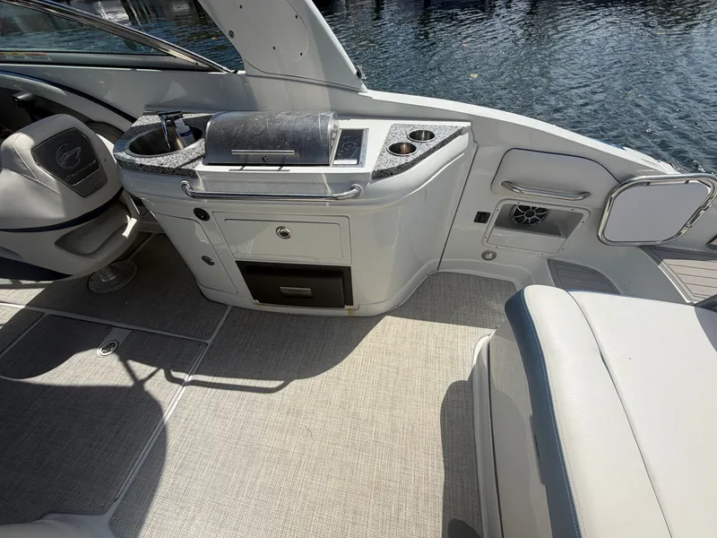 Slide: The Image of Interior of 2023 Crownline Eclipse E285 XS with seating and kitchenette. - 12