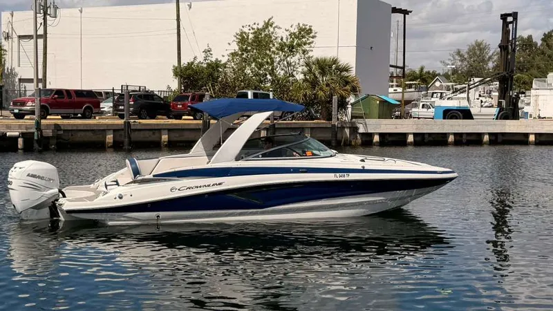 Slide: The Image of 2023 Crownline Eclipse E285 XS boat docked at harbor. - 2