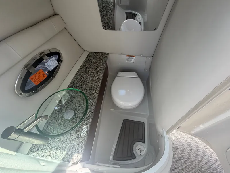 Slide: The Image of Interior of 2023 Crownline Eclipse E285 XS with toilet and sink. - 20
