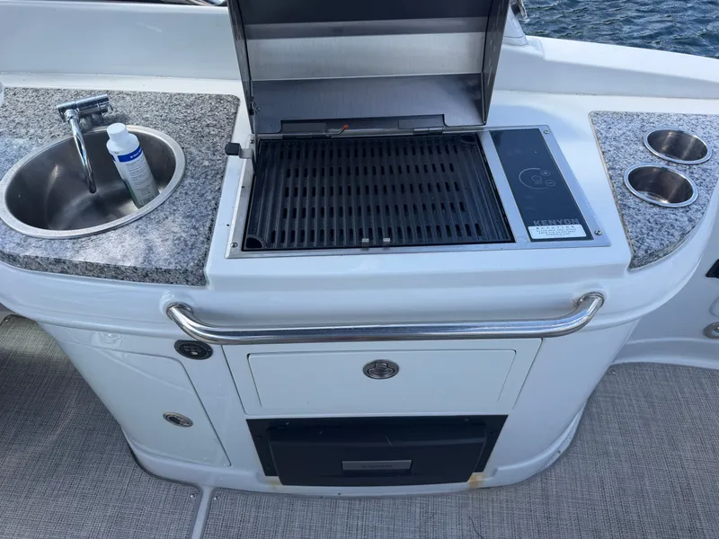 Slide: The Image of Crownline Eclipse E285 XS 2023 boat kitchen with grill and sink. - 21