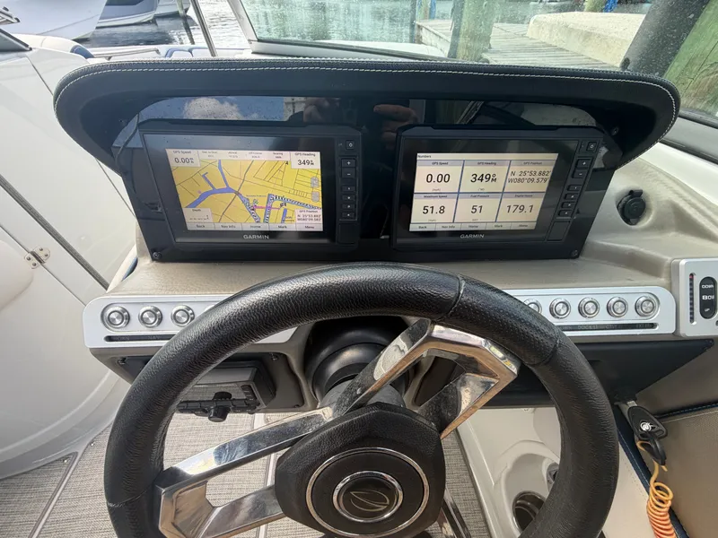 Slide: The Image of Crownline Eclipse E285 XS 2023 dashboard with Garmin GPS displays. - 23