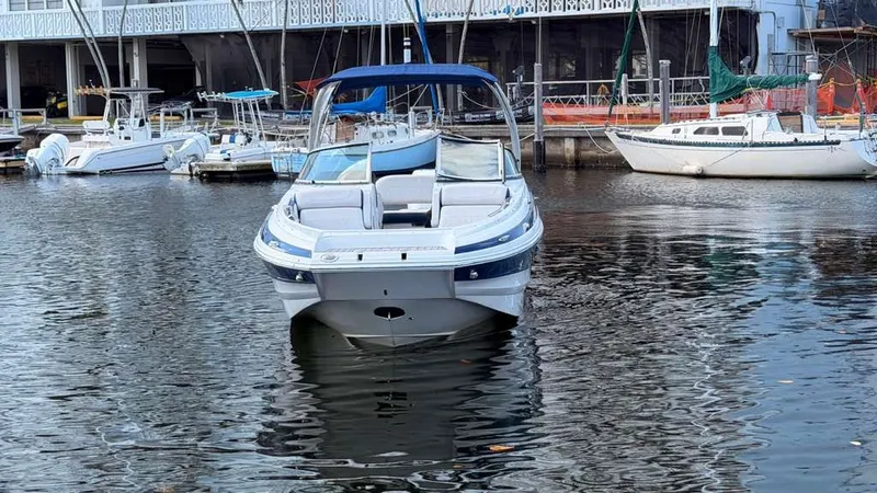 Slide: The Image of 2023 Crownline Eclipse E285 XS boat in harbor. - 5