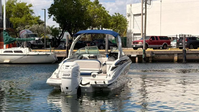 Slide: The Image of 2023 Crownline Eclipse E285 XS boat on water, harbor in background. - 9