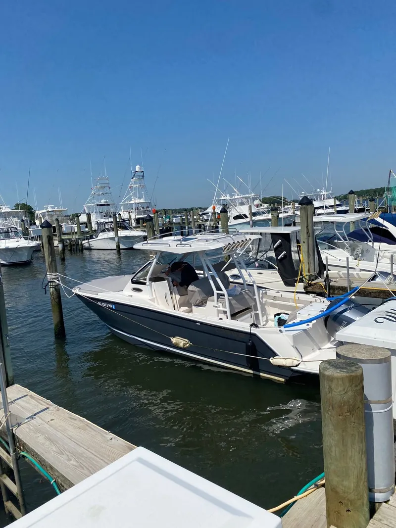 Slide: The Image of 2021 Cutwater C-24 CW boat docked at marina. - 2