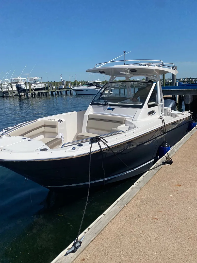 Slide: The Image of 2021 Cutwater C-24 CW boat docked on a sunny day. - 3