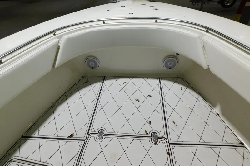 Slide: The Image of 2005 Fountain 34 Center Console boat interior with speakers and patterned flooring. - 10