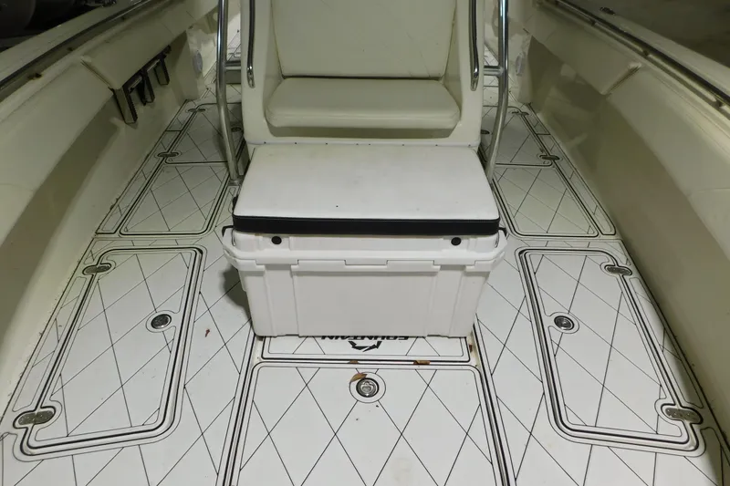 Slide: The Image of 2005 Fountain 34 Center Console boat interior with cushioned seating and patterned flooring. - 13