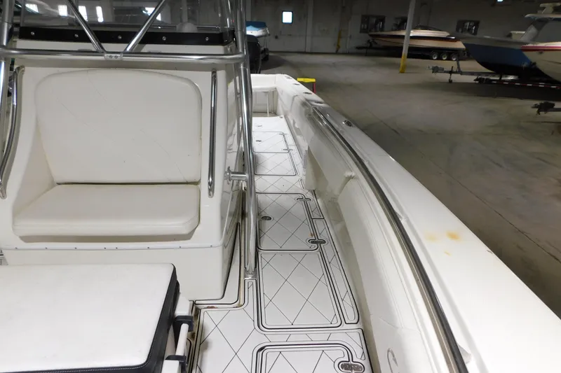 Slide: The Image of 2005 Fountain 34 Center Console boat interior with white seating and patterned flooring. - 14