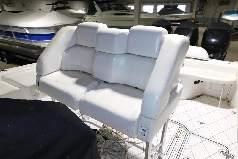 Slide: The Image of 2005 Fountain 34 Center Console boat with white cushioned seating in a storage area. - 16