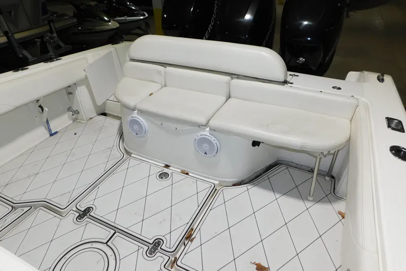 Slide: The Image of 2005 Fountain 34 Center Console boat interior with cushioned seating and patterned flooring. - 17