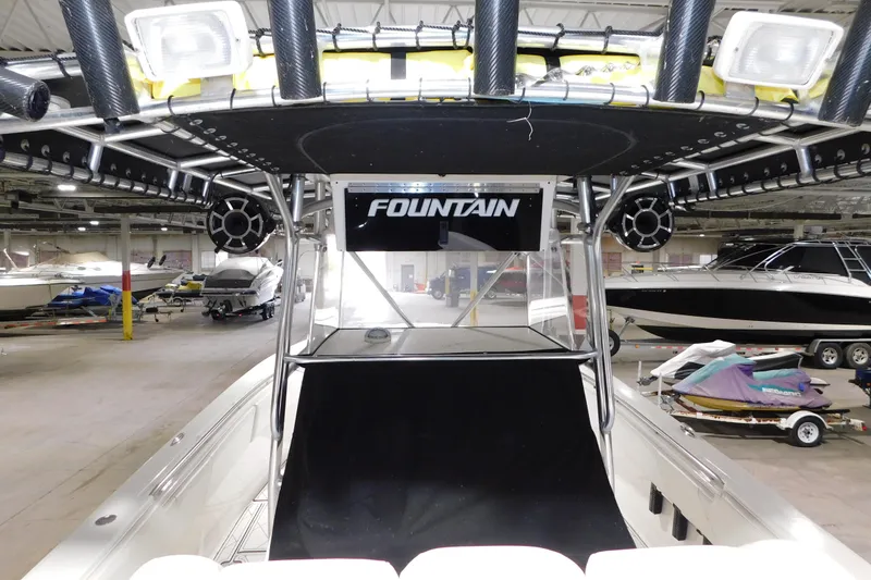 Slide: The Image of 2005 Fountain 34 Center Console boat in indoor storage, surrounded by other vessels. - 18