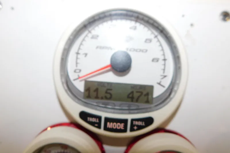 Slide: The Image of Close-up of a 2005 Fountain 34 Center Console tachometer displaying RPM and digital readout. - 21