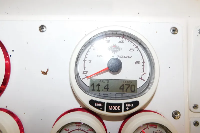Slide: The Image of Close-up of a 2005 Fountain 34 Center Console boat gauge displaying 11.4 volts and 470 hours. - 23